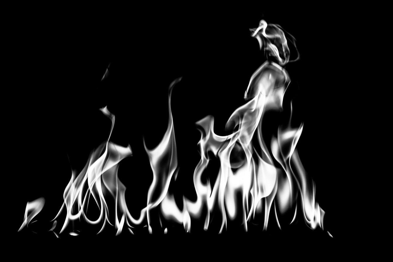 White fire flames on a black background